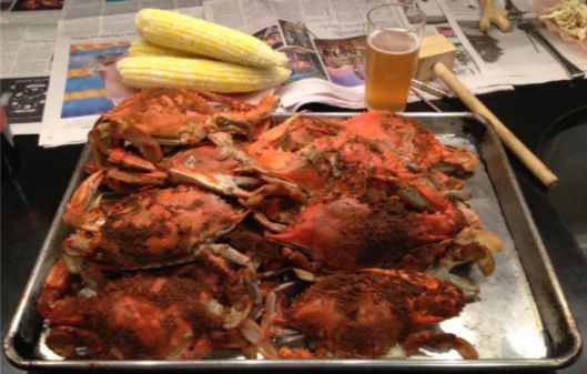 Freshly cooked crab being reheated using different methods—steaming in a pot, oven with foil, microwave with a covered dish, and outdoor grilling. The crab meat looks juicy and tender, with steam rising to show freshness and proper reheating techniques."