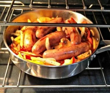 Raw Italian sausages arranged on a baking sheet lined with parchment paper, ready to be cooked in the oven.