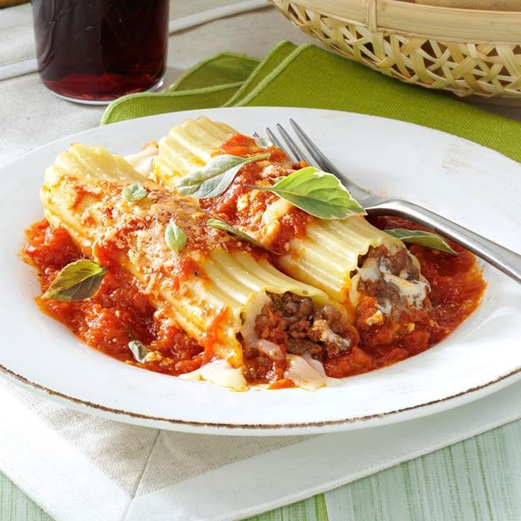 Frozen manicotti in a baking dish with sauce, showing the option to bake directly from frozen or after thawing