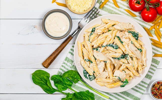 Plate of vibrant, tender frozen fresh pasta cooked al dente, garnished with fresh herbs and grated Parmesan, showcasing convenience and flavor for quick meals.