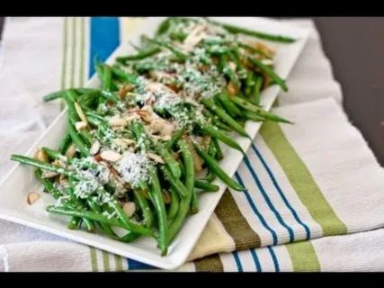 Step-by-step cooking of frozen green beans on stovetop, showing vibrant green beans sautéed in olive oil with garlic, salt, and pepper for a fresh, flavorful side.